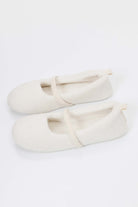 Pair of white slippers on a white background