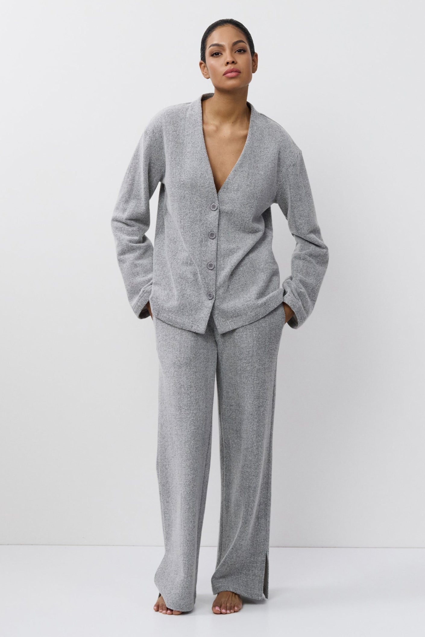 Woman wearing a gray set on a white background