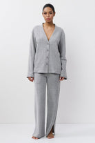Woman wearing a gray set on a white background