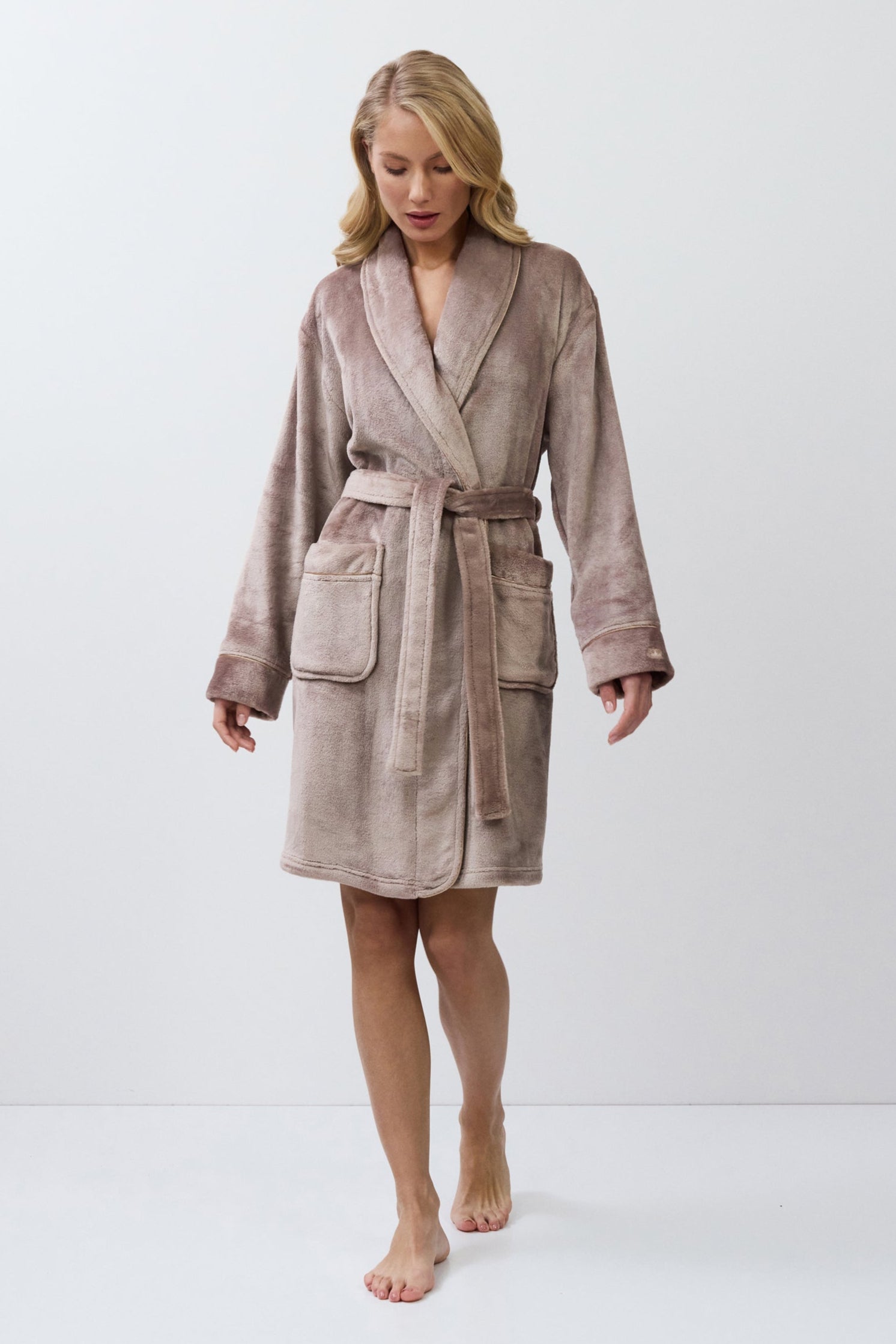 Woman wearing a choco bathrobe on a white background