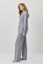 Woman wearing a gray outfit against a white background