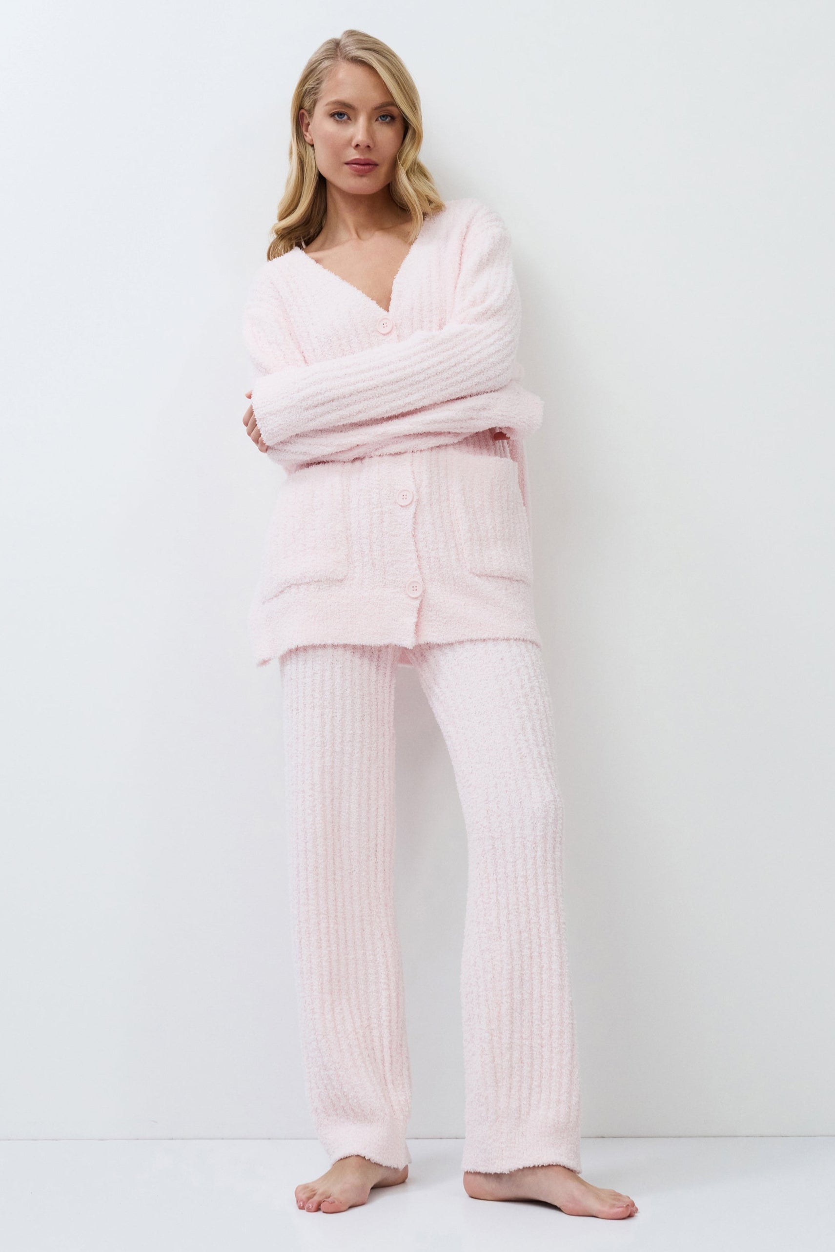 Woman wearing pink set against a white background