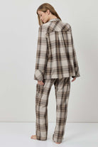 Person wearing a plaid outfit on a white background
