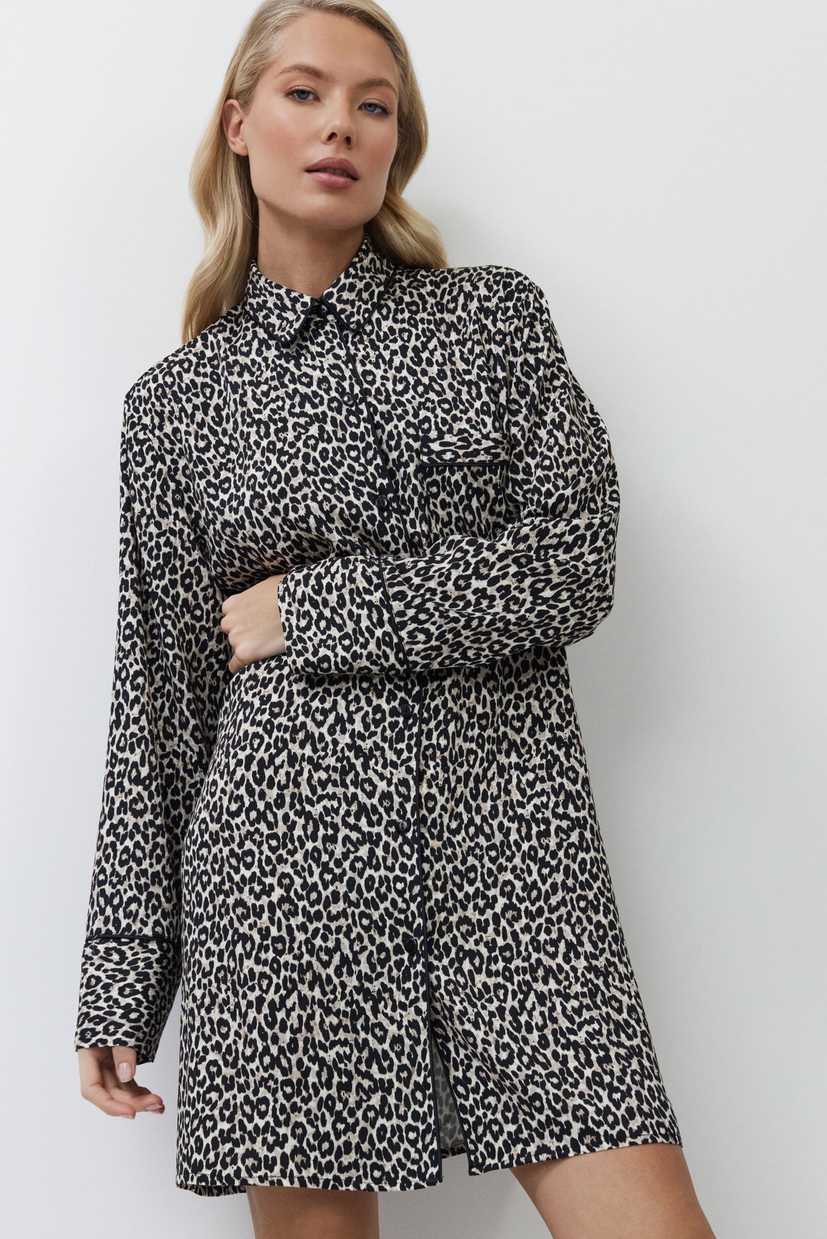 Woman wearing a patterned nightdress on a white background