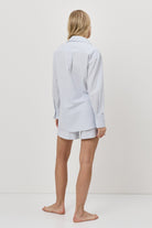 Person wearing a light blue resort wear set on a white background