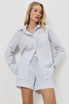 Woman wearing a light blue resort wear set on a white background