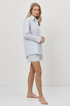 Woman wearing a blue resort wear set on a white background