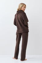 Person wearing a brown outfit on a white background