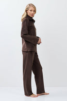 Woman wearing a brown outfit on a white background