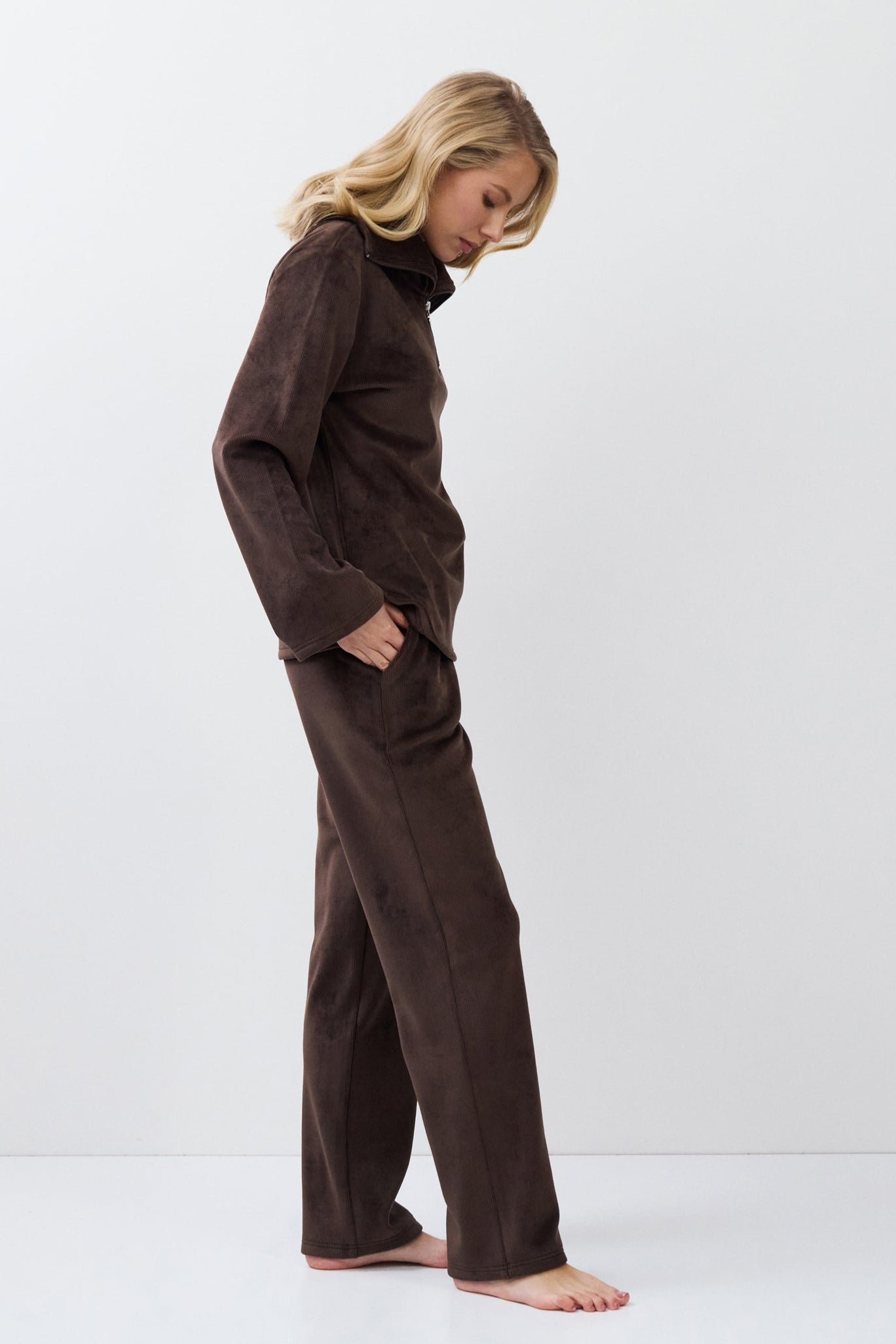 Person wearing a brown set against a white background
