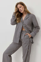 Woman wearing a striped suit against a white background
