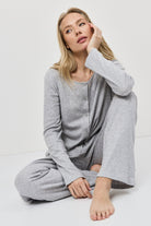 Woman wearing a gray loungewear set on a white background