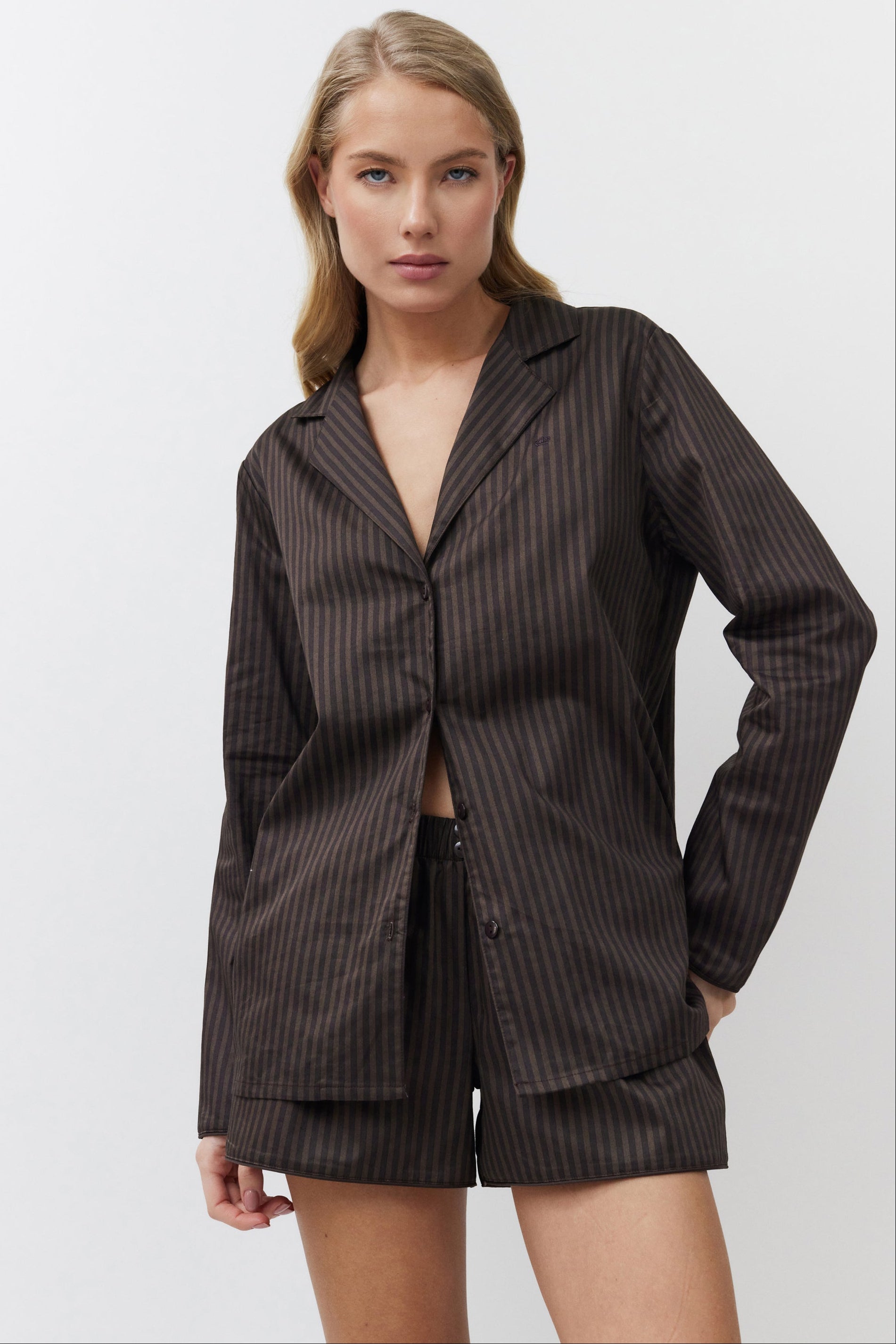 Woman wearing a brown set on a white background