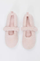 Pair of pink fuzzy slippers on a white background