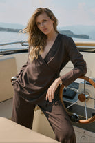 Woman standing on a boat with a scenic background