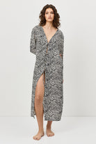 Woman wearing a zebra print dress on a white background