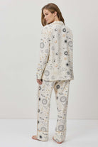 Person wearing a patterned pajama set on a white background