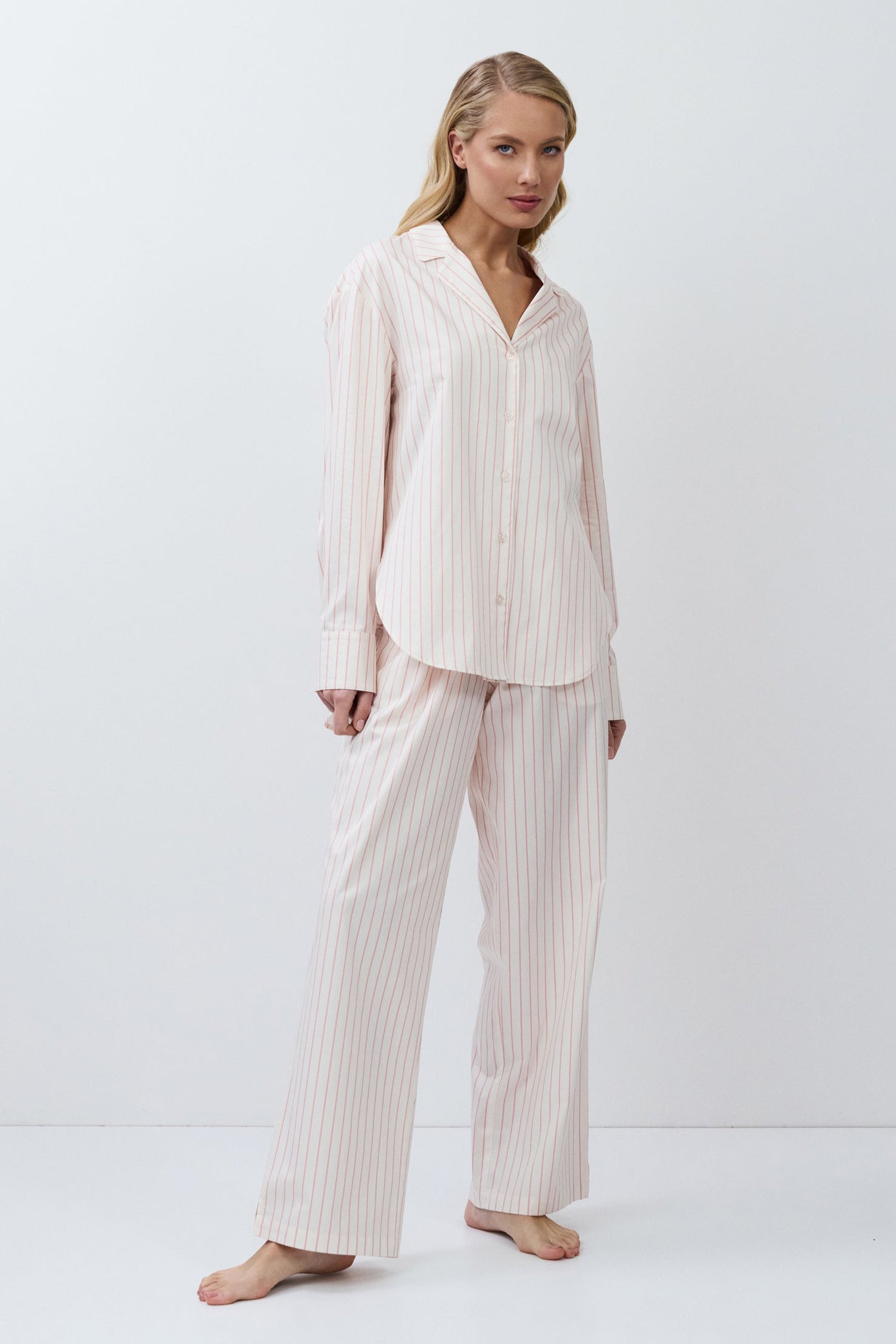 Woman wearing a = pajama set with a white background